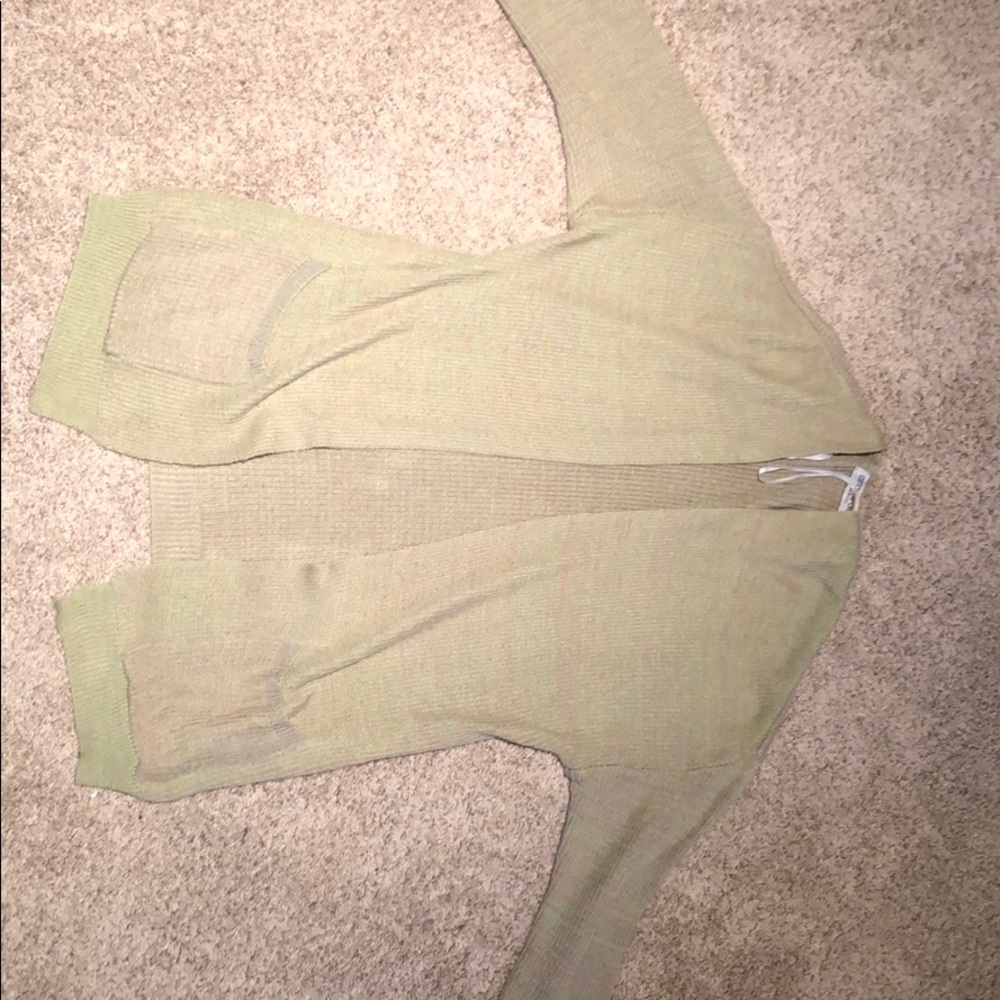 A light green and pink sweater cardigan